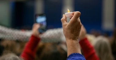 A mourner holds a candle at a vigil service for Wadea al-Fayoume, 6, a Muslim boy who was stabbed to death in an attack that targeted him and his mother for their religion and as a response to the Israel-Hamas war, in Plainfield, Illinois, U.S., Oct. 17, 2024. (Reuters Photo)