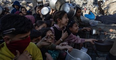 Internally displaced Palestinian children push themselves in line to receive a portion of food from a charity kitchen before the iftar meal, in Beit Lahia, northern Gaza Strip, Palestine, March 10, 2025. (EPA Photo)