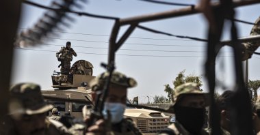 U.S.-backed PKK/YPG-led SDF fighters sit on their armored vehicles, at al-Sabha town in the eastern countryside of Deir el-Zour, Syria, Monday, Sept. 4, 2023. (AP File Photo)