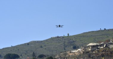 An Israeli drone flies during a mass funeral of Hezbollah fighters who died during fights with the Israeli army before the cease-fire, in Kfar Kila village, southern Lebanon, March 9, 2025. (EPA Photo)