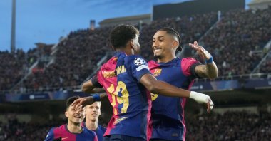 Barcelona&#039;s Raphinha (R) celebrates his 1-0 goal with Lamine Yamal (C) during the UEFA Champions League round of 16 second leg match against Benfica, at the Estadi Olimpic Lluis Companys, Barcelona, Spain, March 11, 2025. (EPA Photo)