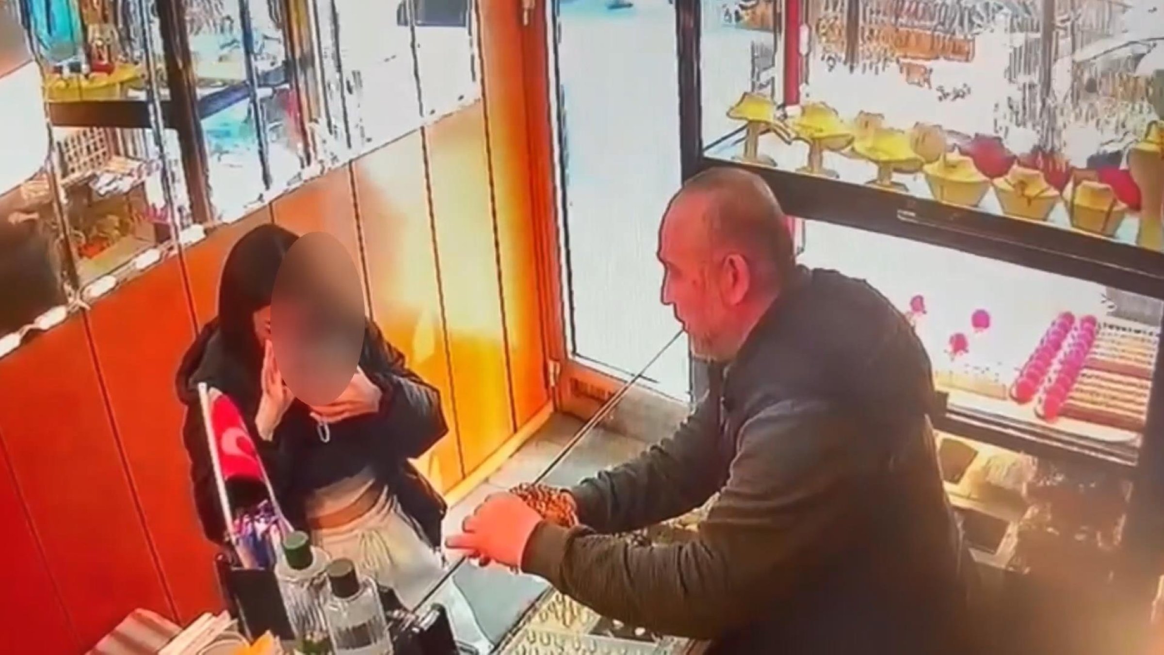 Security camera footage shows the woman taking a photo of the gold crown before stealing it in Istanbul, Türkiye, March 6, 2025. (DHA Photo)