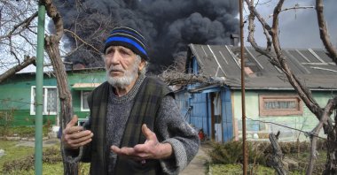 A man reacts as smoke billows above the site of a drone attack, Odesa, Ukraine, March 11, 2025. (EPA Photo)