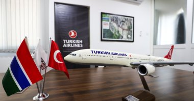 The flags of Gambia and Türkiye, along with a model of Turkish Airlines, are seen at an undisclosed location on March 11, 2025. (AA Photo)