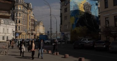 Pedestrians walk past a military mural in the Podil neighborhood in Kyiv, Ukraine, March 11, 2025. (AFP Photo)