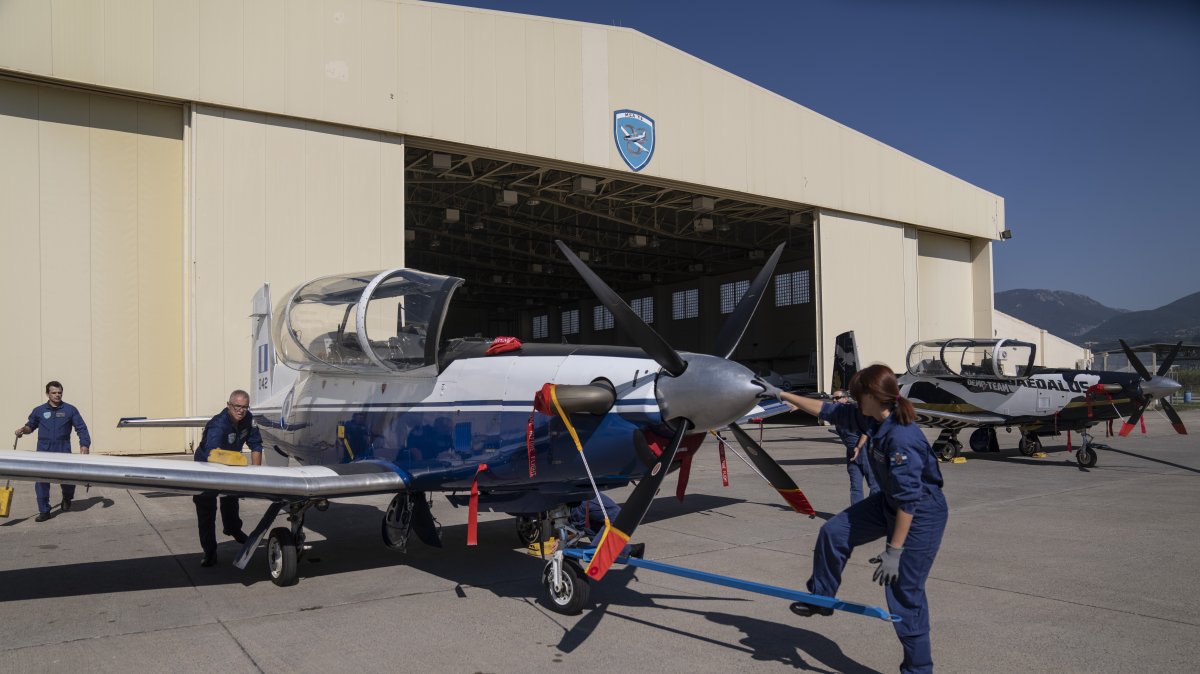 Greek airforce maintenance staff park a T-6 single-engine turboprop training aircraft at an airbase, Kalamata, Greece, Oct. 21, 2022. (AP Photo)