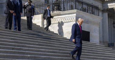 U.S. President Donald Trump (R) departs the Capitol as Speaker of the House Mike Johnson (L) and the Taoiseach of Ireland Micheal Martin (R) look on following the Friends of Ireland Luncheon at the U.S. Capitol in Washington, U.S., March 12, 2025. (EPA Photo)