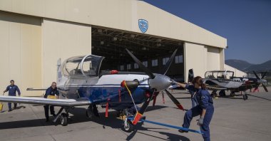 Greek airforce maintenance staff park a T-6 single-engine turboprop training aircraft at an airbase, Kalamata, Greece, Oct. 21, 2022. (AP Photo)