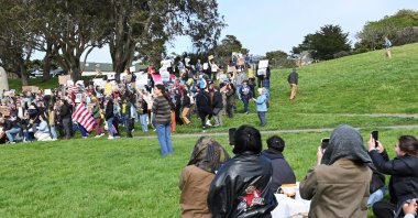 San Francisco residents having a picnic, photograph a group of protesters during a demonstration as part of a nationwide series of protests planned at federal park sites, against the mass firings of National Park Service employees in a campaign by President Donald Trump and his adviser Elon Musk to radically cut back the U.S. bureaucracy, at Fort Mason Park in San Francisco, California, U.S. March 1, 2025. (Reuters Photo)