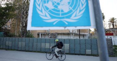 A man crosses the Ledra Palace checkpoint on his bicycle in the U.N. buffer zone, Nicosia, Cyprus, Dec. 5, 2024. (Reuters Photo)
