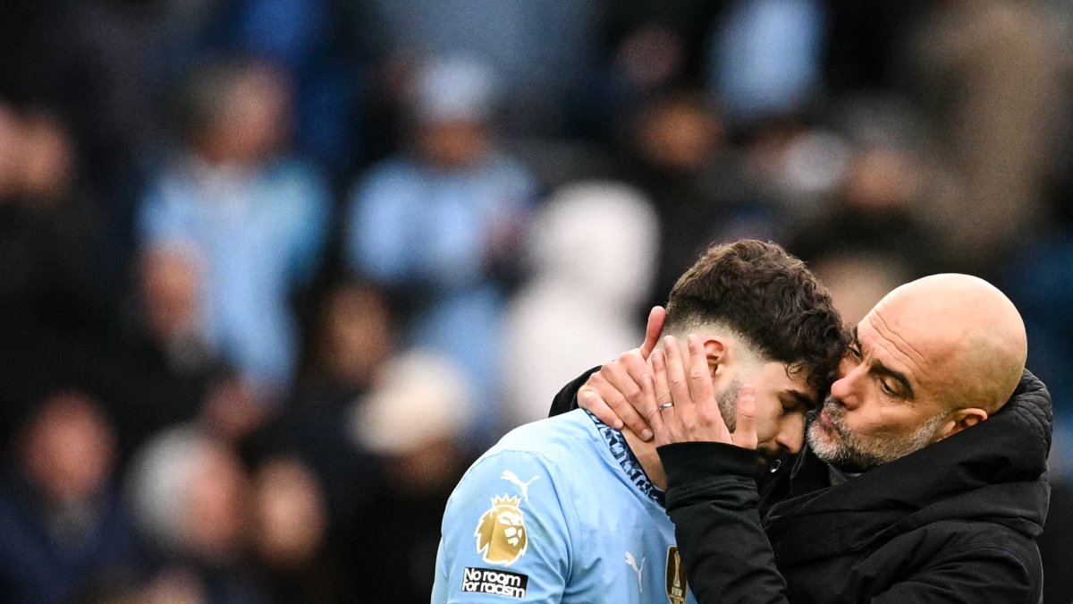 Manchester City's Spanish manager Pep Guardiola (R) kisses Croatian defender Josko Gvardiol (L) at the end of a Premier League match against Brighton, in Manchester, U.K., March 15, 2025. (AFP Photo)