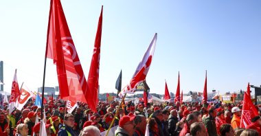 People wave flags and banners as they gather a rally organized by the IG Metall trade union in Cologne, Germany, March 15, 2025. (EPA Photo)