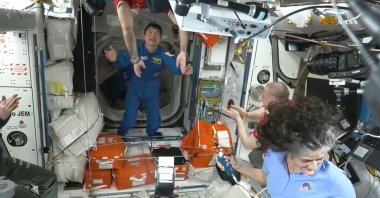 This screengrab made from a NASA livestream shows the SpaceX Dragon Crew-10 member astronaut Takuya Onishi (C) greets members of the International Space Station (ISS) crew shortly after docking at the ISS, March 16, 2025. (AFP Photo)