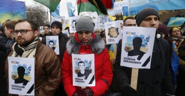 Ukrainian and Crimean Tatar activists hold portraits with the names of victims of the Russian annexation of Crimea, Kyiv, Ukraine, Feb. 26, 2017. (AP Photo)