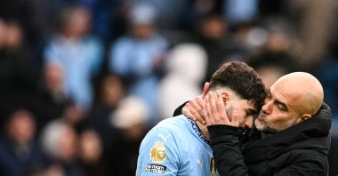 Manchester City's Spanish manager Pep Guardiola (R) kisses Croatian defender Josko Gvardiol (L) at the end of a Premier League match against Brighton, in Manchester, U.K., March 15, 2025. (AFP Photo)