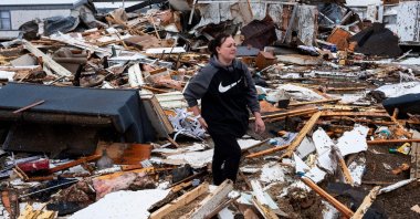 Stevie Kara searches for personal items after her home was destroyed in Poplar Bluff, Missouri, March 15, 2025. (AFP Photo)