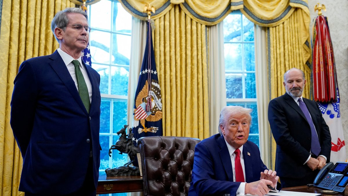 U.S. Treasury Secretary Scott Bessent (L) and Commerce Secretary Howard Lutnick (R) stand as U.S. President Donald Trump speaks, the White House, Washington, U.S., Feb. 3, 2025.