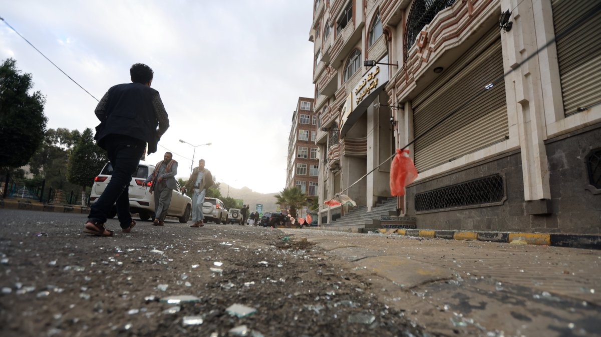 People pass a cordoned-off area a day after U.S. airstrikes targeted a nearby position, in Sanaa, Yemen, March 16, 2025. (EPA Photo)