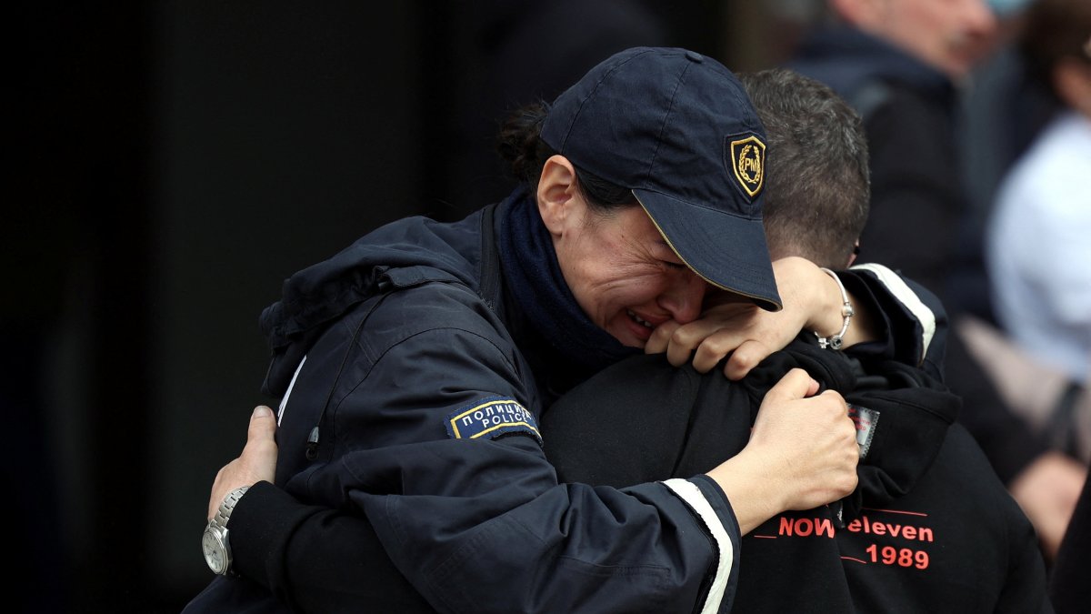 A police officer cries while hugging a person outside a hospital following a fire that killed at least 59 in Kocani, North Macedonia, March 17, 2025. (Reuters Photo)