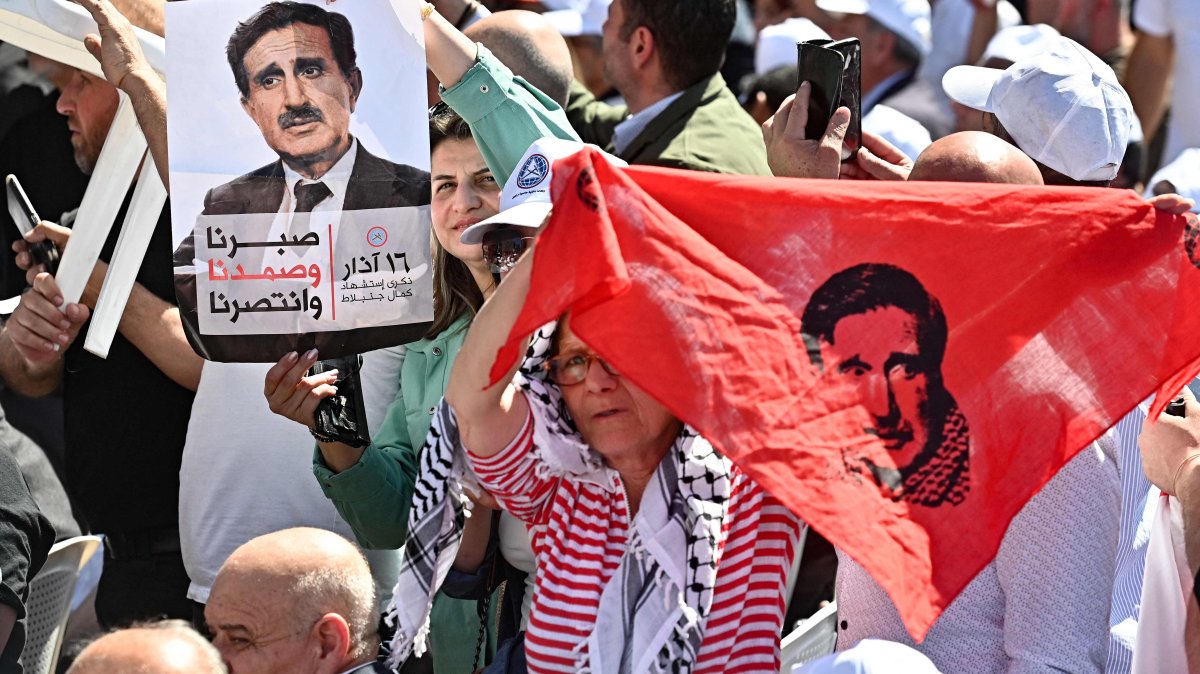 People lift portraits of late Druze leader Kamal Jumblatt during a ceremony marking the 48th anniversary of his assassination at the El-Moukhtara Palace in Lebanon&#039;s Shouf mountains, March 16, 2025. (AFP Photo)