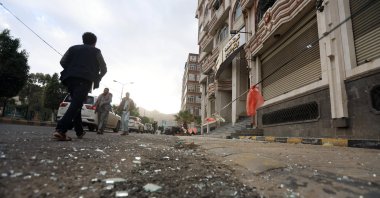 People pass a cordoned-off area a day after U.S. airstrikes targeted a nearby position, in Sanaa, Yemen, March 16, 2025. (EPA Photo)