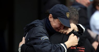 A police officer cries while hugging a person outside a hospital following a fire that killed at least 59 in Kocani, North Macedonia, March 17, 2025. (Reuters Photo)