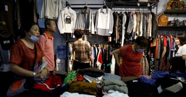 Customers shop for clothes at a stall inside a wholesale market, Beijing, China, Sept. 8, 2023. (Reuters Photo)