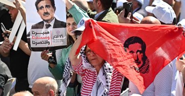People lift portraits of late Druze leader Kamal Jumblatt during a ceremony marking the 48th anniversary of his assassination at the El-Moukhtara Palace in Lebanon's Shouf mountains, March 16, 2025. (AFP Photo)