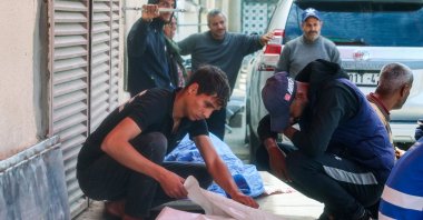 Relatives mourn by the bodies of three Palestinian men who were killed in an Israeli drone strike east of the Bureij camp, at the al-Aqsa Martyrs hospital morgue in Deir el-Balah in the central Gaza Strip, Palestine, March 17, 2025. (AFP Photo)