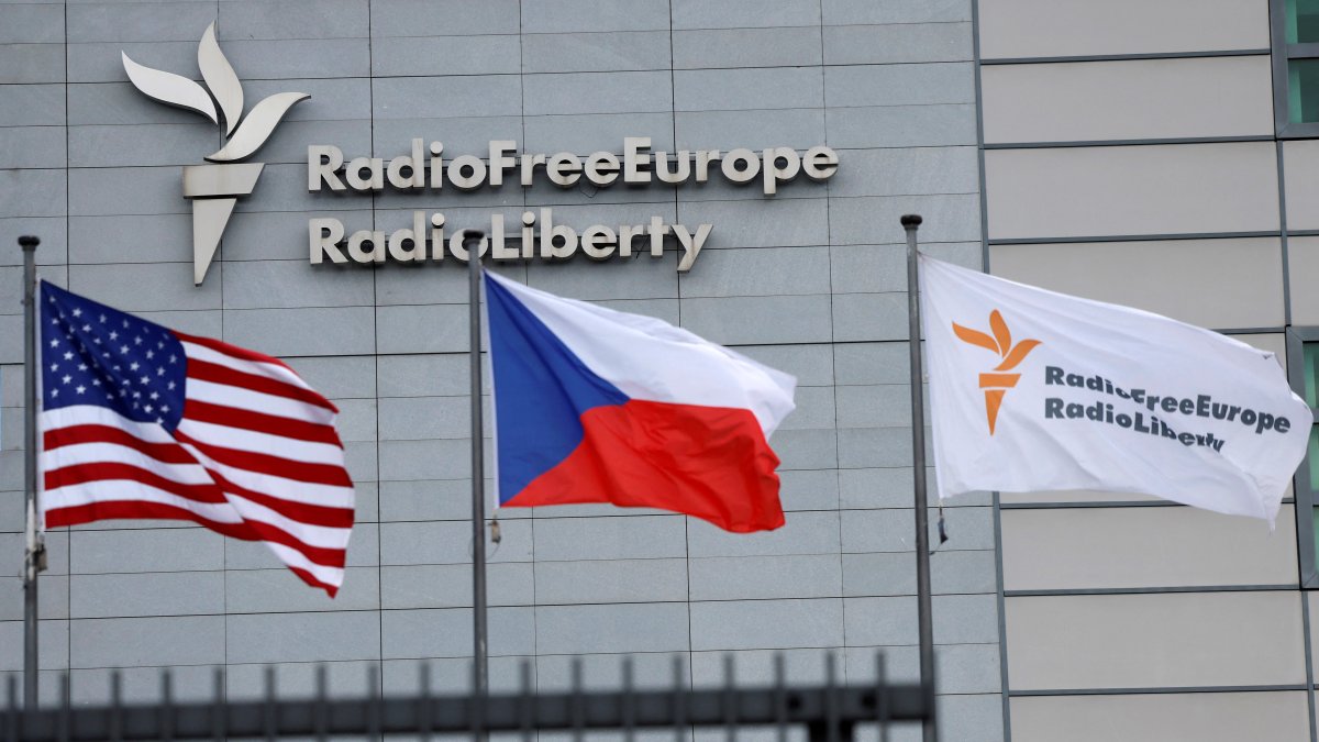 A sign and flags are shown at the headquarters of Radio Free Europe/Radio Liberty in Prague, Czechia, March 17, 2025. (Reuters Photo)