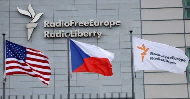 A sign and flags are shown at the headquarters of Radio Free Europe/Radio Liberty in Prague, Czechia, March 17, 2025. (Reuters Photo)