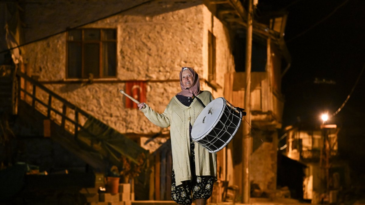 Ayşe Alkan plays the Ramadan drum while walking through the streets of Kuzköy, Burdur, Türkiye, March 18, 2025. (AA Photo) 