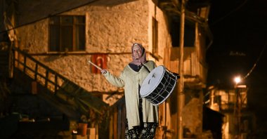 Ayşe Alkan plays the Ramadan drum while walking through the streets of Kuzköy, Burdur, Türkiye, March 18, 2025. (AA Photo) 