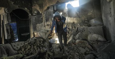 A Palestinian inspects a destroyed house belonging to the Hattab family following an Israeli airstrike in Gaza, Palestine, March 19, 2025. (EPA Photo)