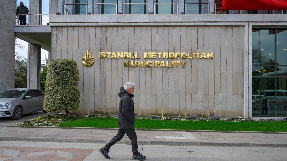 A pedestrian walks in front of the Istanbul Municipality headquarters, Istanbul, Türkiye, March 19, 2025. (AFP Photo)