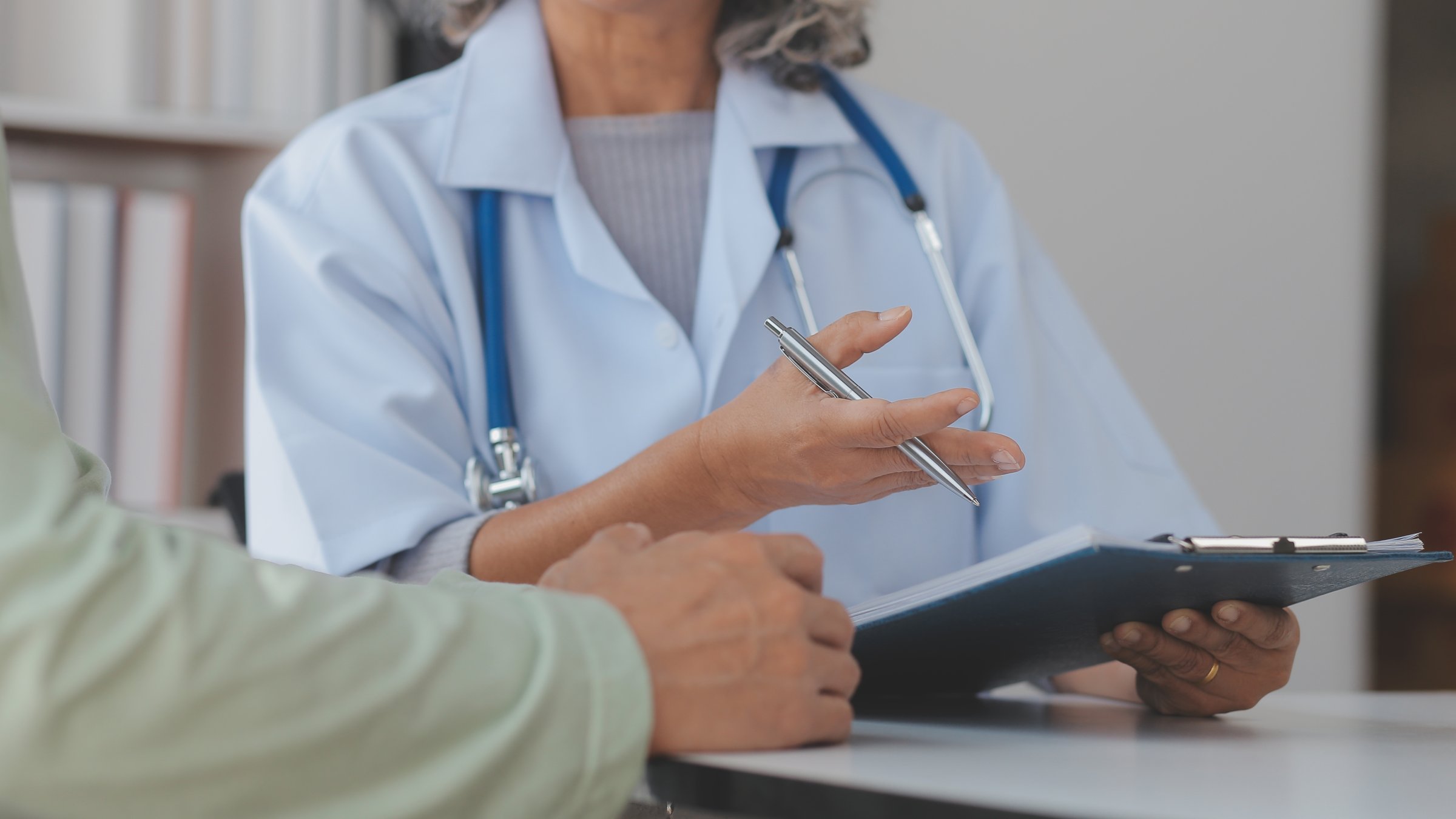 A doctor discusses test results with a patient during a medical consultation. (Shutterstock Photo) 
