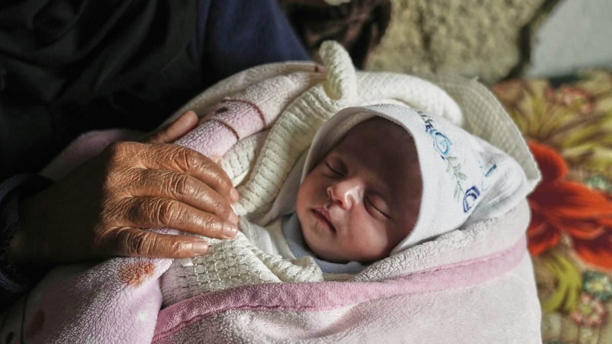 Ella Osama Abu Dagga, 25 days old, is held by her great-aunt Suad Abu Dagga after she was pulled from the rubble earlier following an Israeli army airstrike that killed her parents and brother in Khan Younis, Gaza Strip, Palestine, March 20, 2025. (AP Photo)