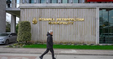 A pedestrian walks in front of the Istanbul Municipality headquarters, Istanbul, Türkiye, March 19, 2025. (AFP Photo)