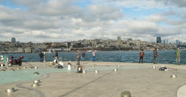 Fishermen are seen on the shores of the Bosporus, Istanbul, Türkiye, Dec. 5, 2024. (Reuters Photo)