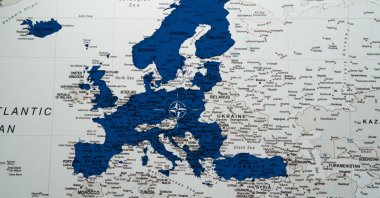 A NATO alliance flag on a European map. (Shutterstock Photo)