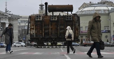 People walk past equipment retrieved from a Ukrainian power plant struck by Russian forces and put on display in the Podil neighborhood of Kyiv, Ukraine, March 19, 2025. (AFP Photo)