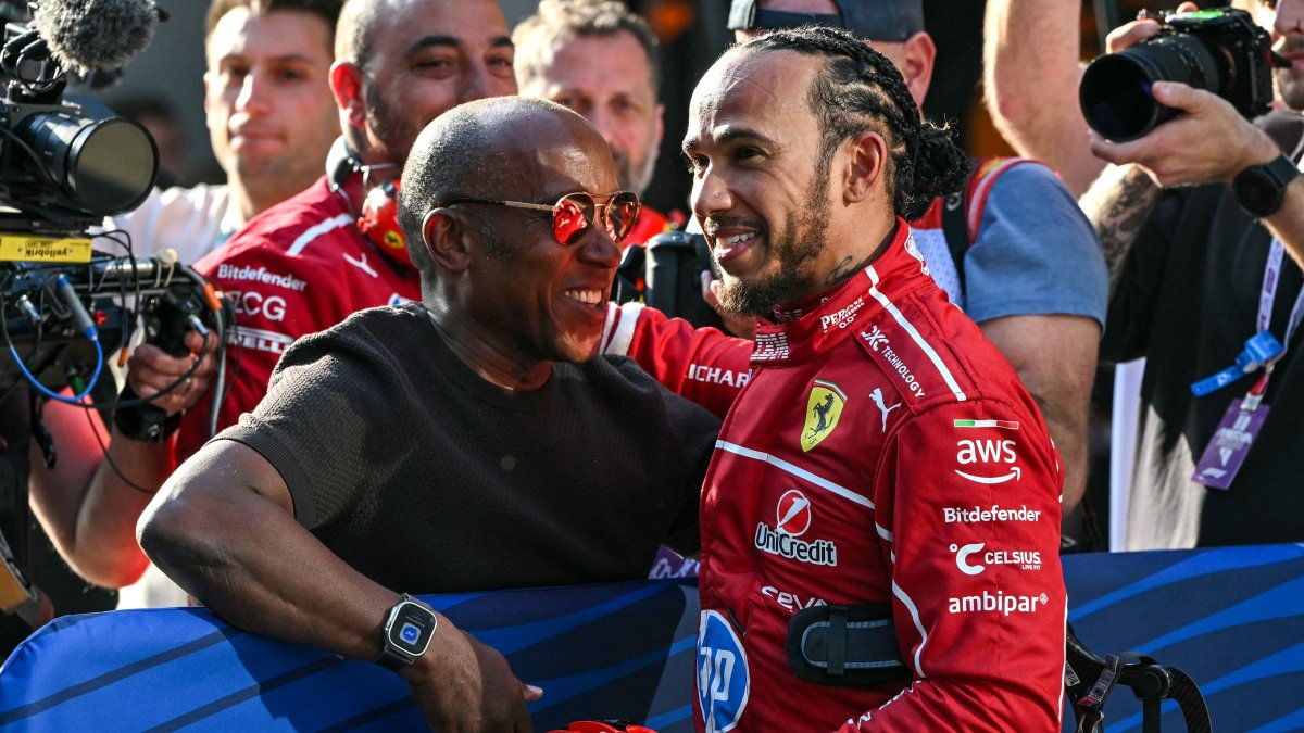 Ferrari&#039;s British driver Lewis Hamilton (R) celebrates taking pole position with his father Anthony Hamilton after the sprint qualifying session of the Formula One Chinese Grand Prix at the Shanghai International Circuit, Shanghai, China, March 21, 2025. (AFP Photo)
