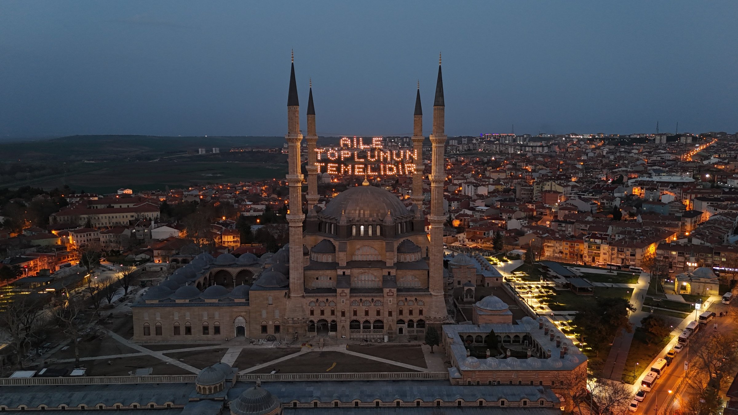 The illuminated mahya reading &quot;Family is the foundation of society&quot; hangs the minarets of Selimiye Mosque, Edirne, Türkiye, March 17, 2025. (IHA Photo)