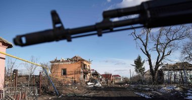 Russian soldiers walk past destroyed houses in the village of Kazachya Loknya, which was previously held by Ukrainian troops and recently retaken by Russia, Sudzha district, Kursk, Russia, March 18, 2025. (AFP Photo)