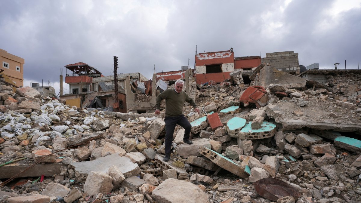 A man walks on the rubble of buildings after Israeli troops withdrew from most of south Lebanon, in Mays al-Jabal, south Lebanon near the border with Israel, Feb. 19, 2025. (Reuters Photo)
