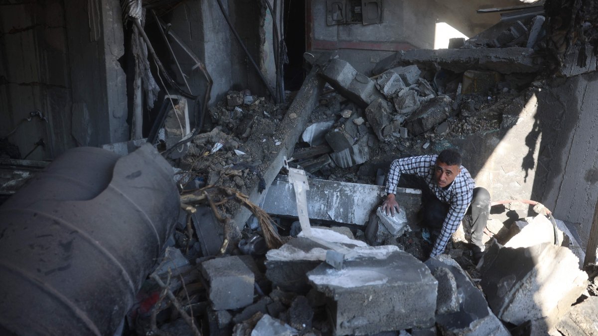 A Palestinian man inspects the rubble and debris at the site of Israeli strikes at the Nuseirat refugee camp, central Gaza, Palestine, March 23, 2025. (AFP Photo)