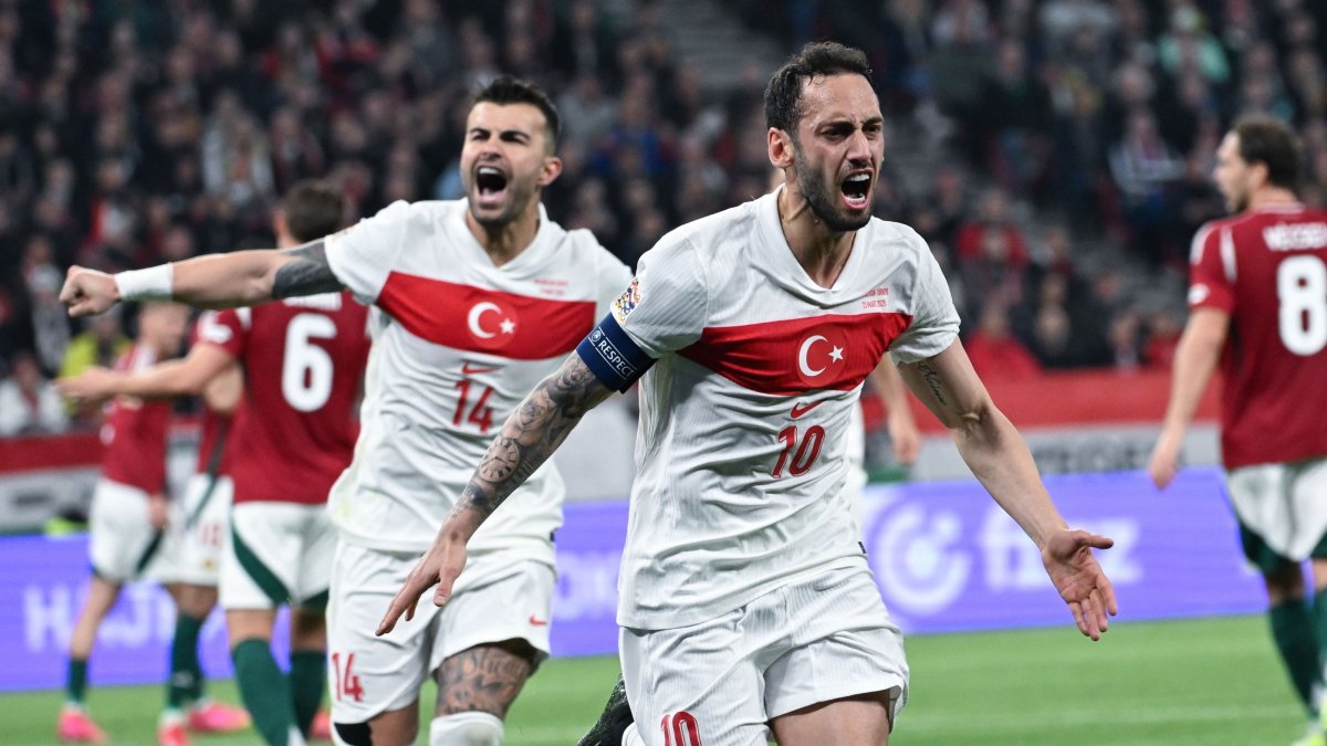 Türkiye&#039;s Hakan Çalhanoğlu (R) celebrates with teammate Abdülkerim Bardakçı after he scored a goal during the UEFA Nations League Division A playoff second leg match against Hungary at Puskas Arena, Budapest, Hungary, March 23, 2025. (EPA Photo)