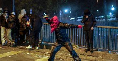 A masked rioter throws a projectile at police, Istanbul, Türkiye, March 22, 2025. (AFP Photo)