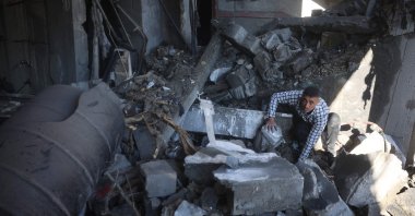 A Palestinian man inspects the rubble and debris at the site of Israeli strikes at the Nuseirat refugee camp, central Gaza, Palestine, March 23, 2025. (AFP Photo)