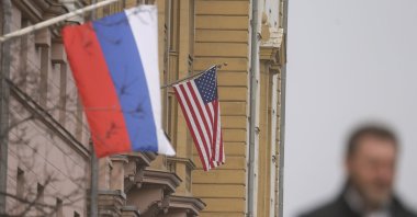A man walks near Russian and U.S. flags hanging on the main building of the U.S. Embassy in Moscow, Russia, March 12, 2025. (EPA Photo)